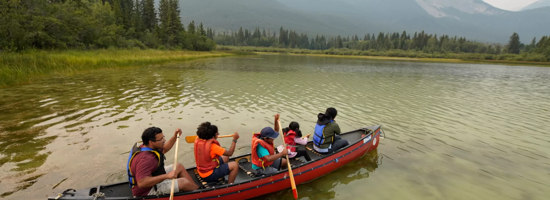 Family canoeing on lake