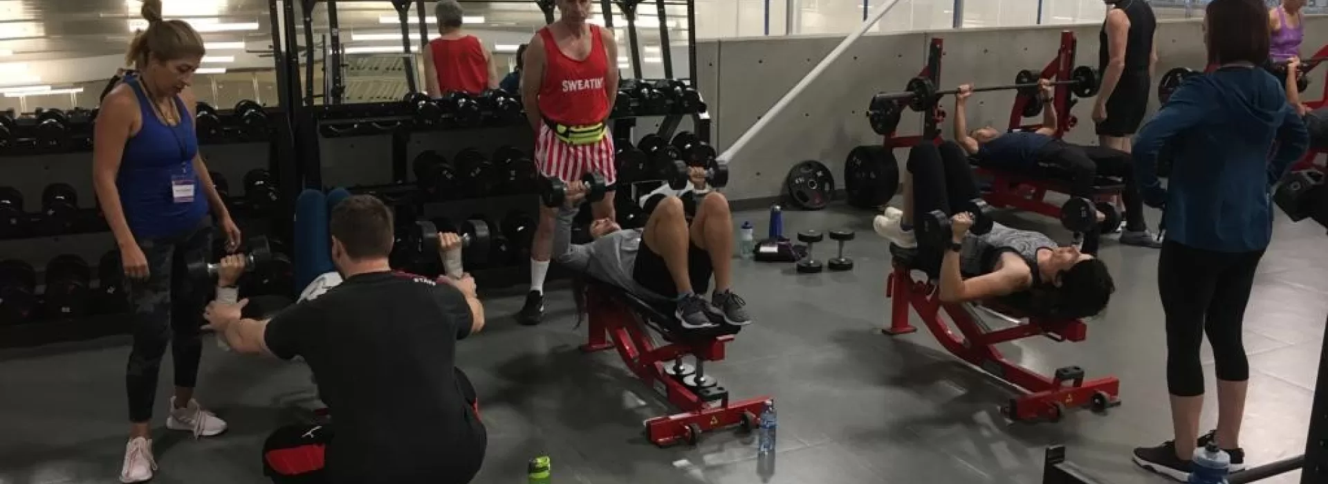 group of people lifting weights together