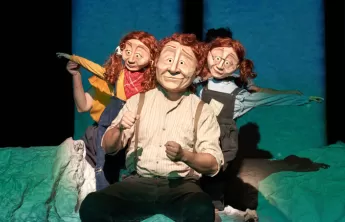 Family consisting of a dad and twin daughters wearing masks