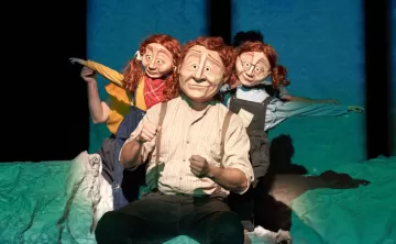 Family consisting of a dad and twin daughters wearing masks